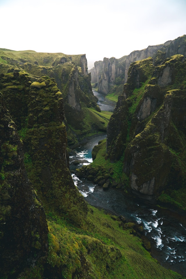 A river winding through a green canyon in Iceland